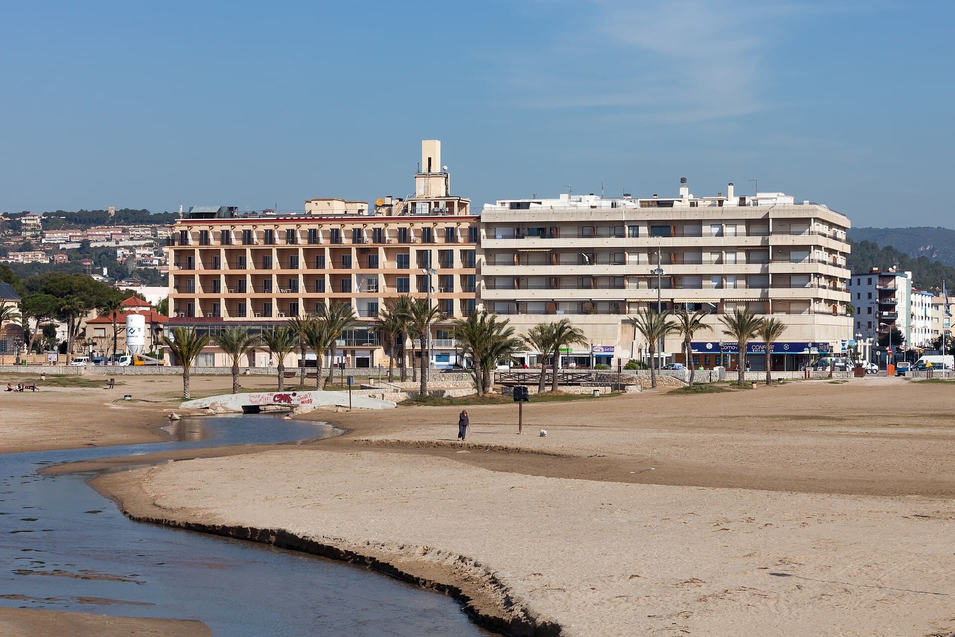 Hotels and palm trees along the seafront at Coma-ruga beach